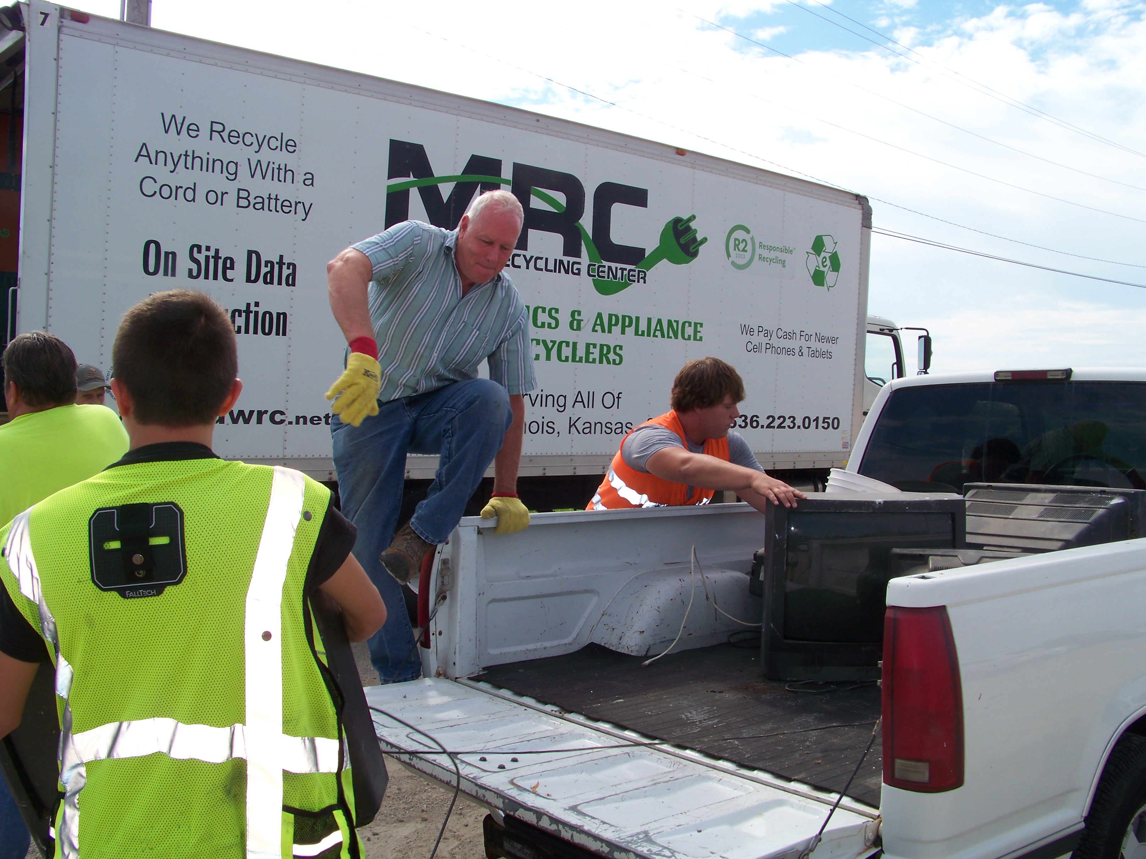 loading items into a truck - Ozark Rivers Solid Waste Management District