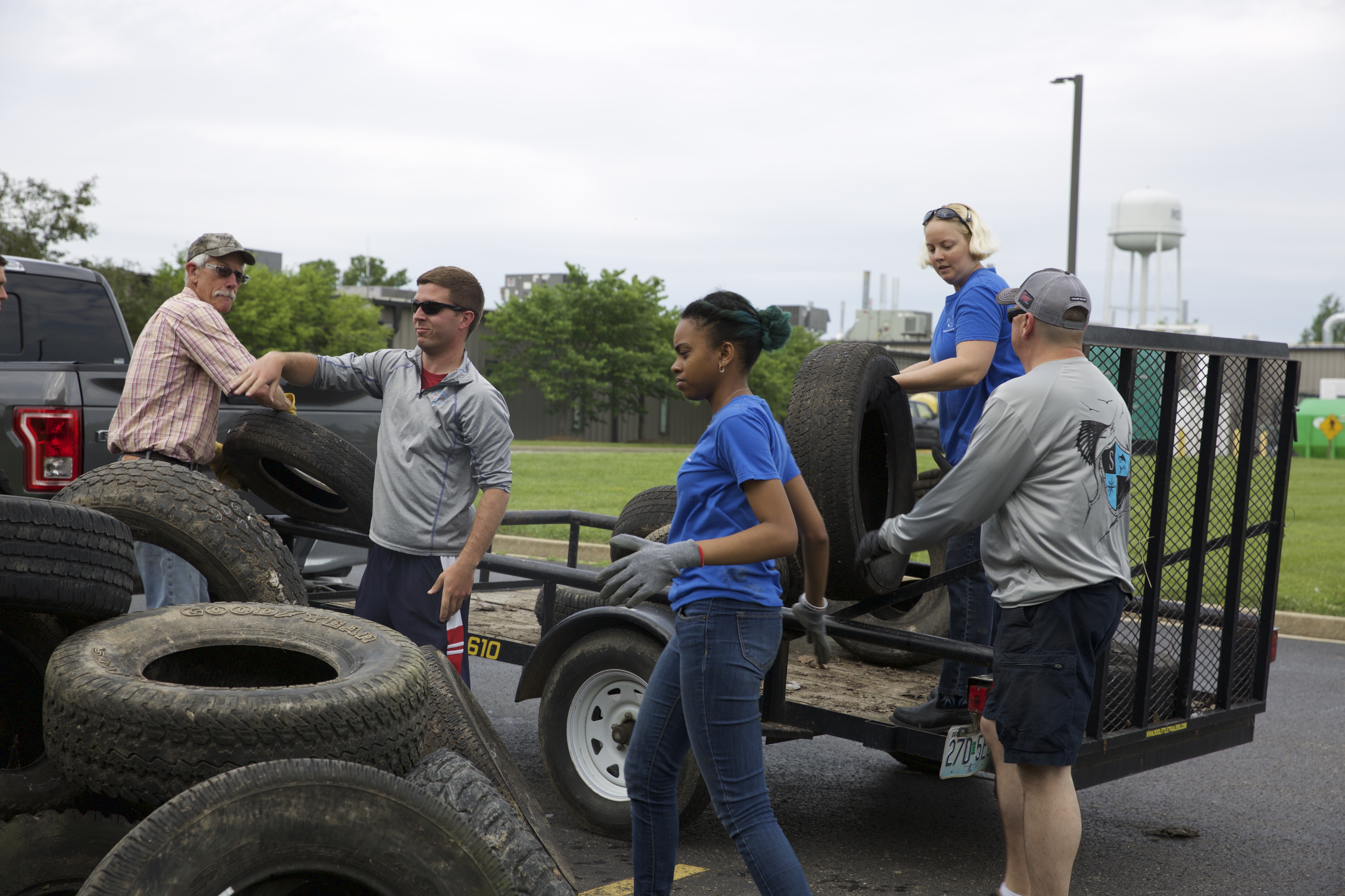 group of people loading tires on a trailer - Ozark Rivers Solid Waste Management District
